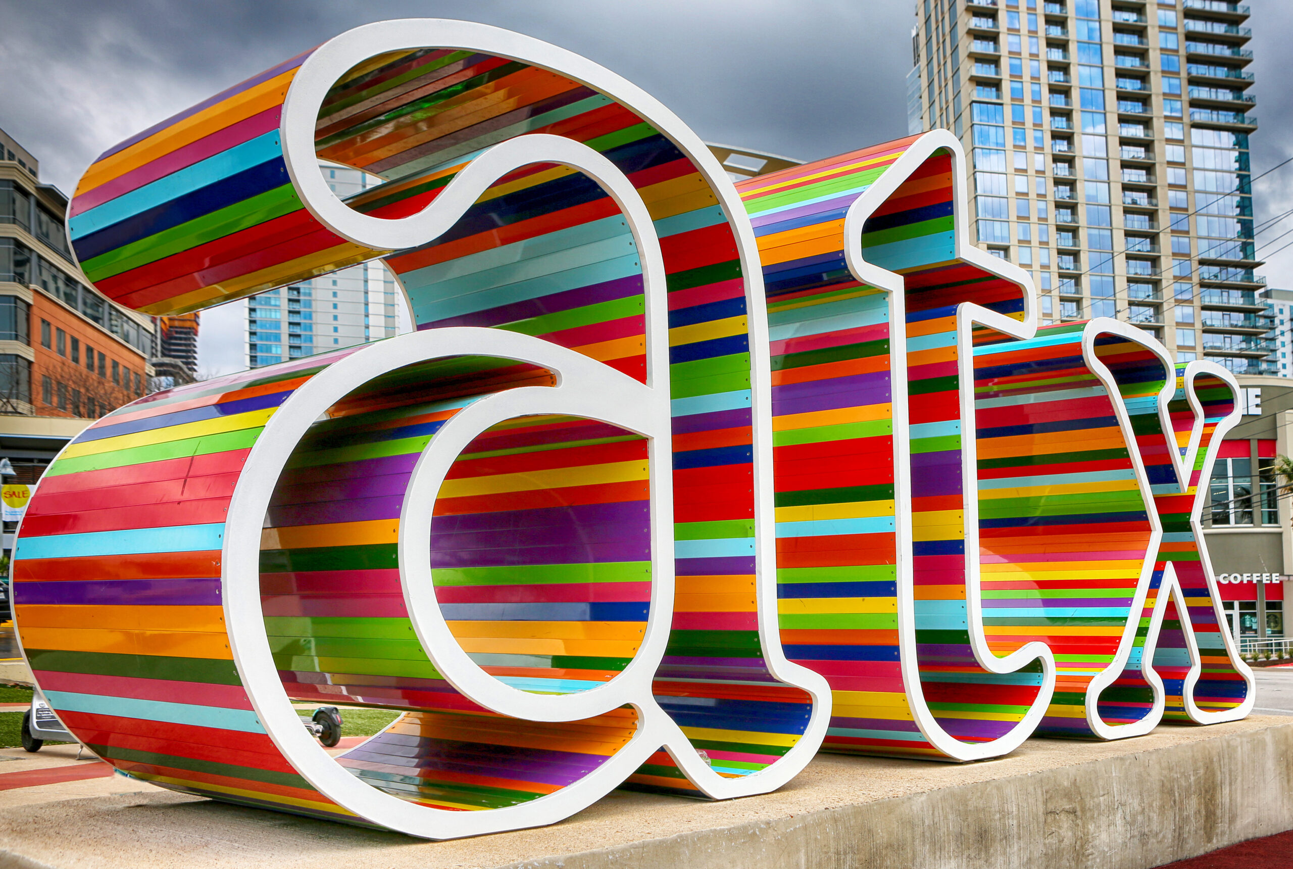 3D colorfully decorated life-size letters of lowercase ATX.